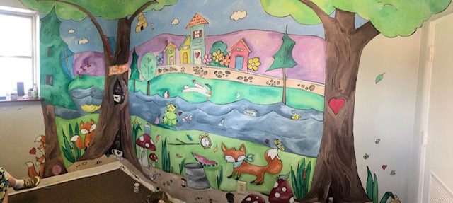 A mural of foxes along a river.