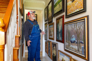 Bart looking at his paintings on his wall
